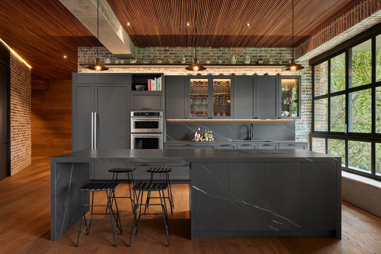 Dark porcelain kitchen with architectural cabinetry and integrated worktops