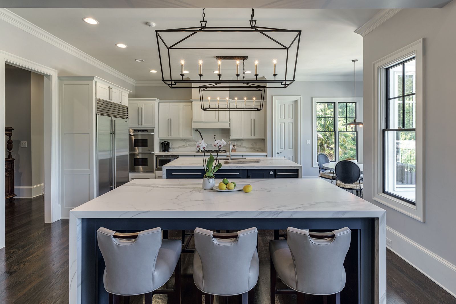 Bright statement kitchen with a marble-effect waterfall island